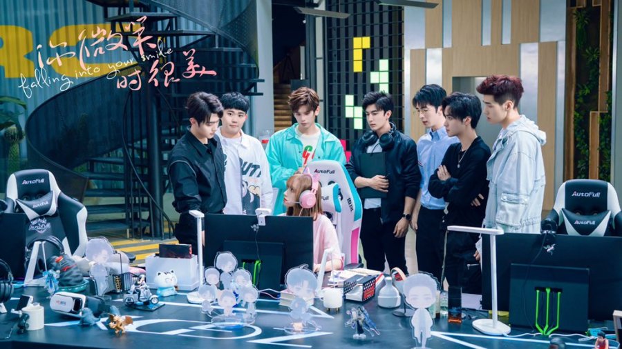still from falling into your smile drama where the cast surrounds Yao as she plays a game